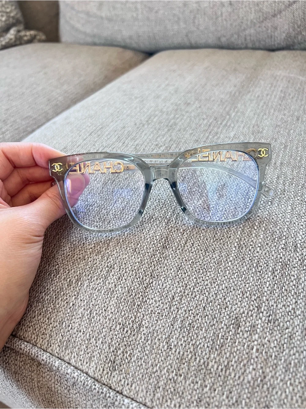 CHANEL Transparent Light Blue Frame Glasses with Gold Logos